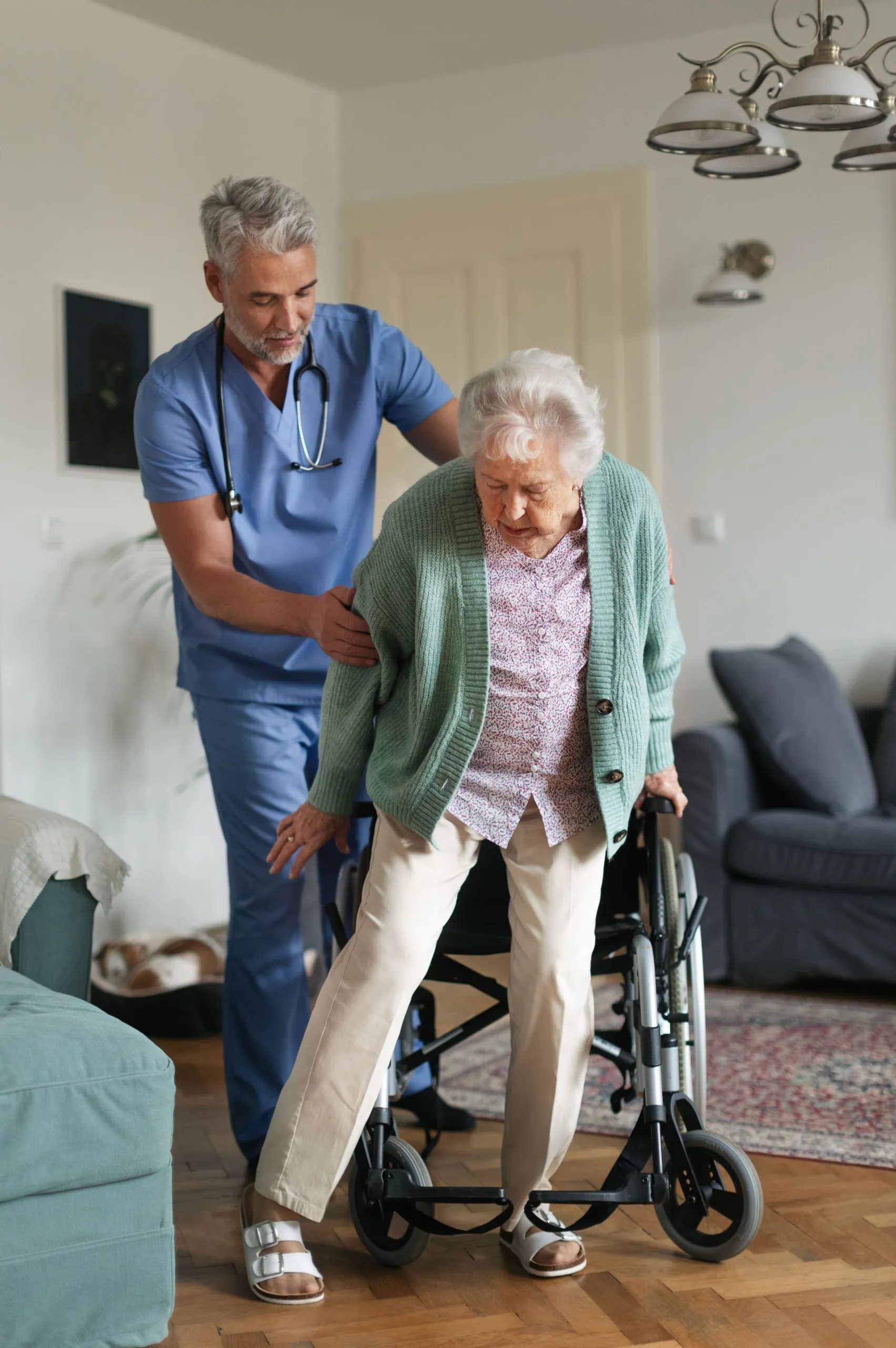 Caregiver helping a senior woman stand
